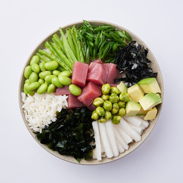 Inti Poke bowl with tuna, edamame, avocado, seaweed, rice, and green onions.