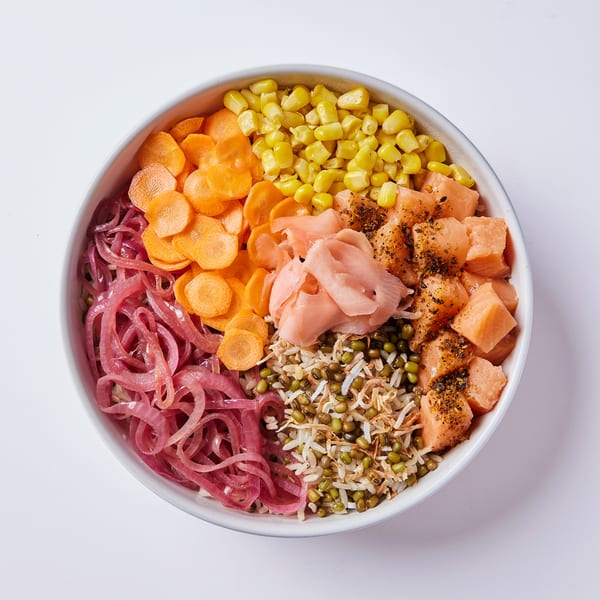 Inti Poke bowl with salmon, corn, carrots, pickled onions, mung beans, and ginger.