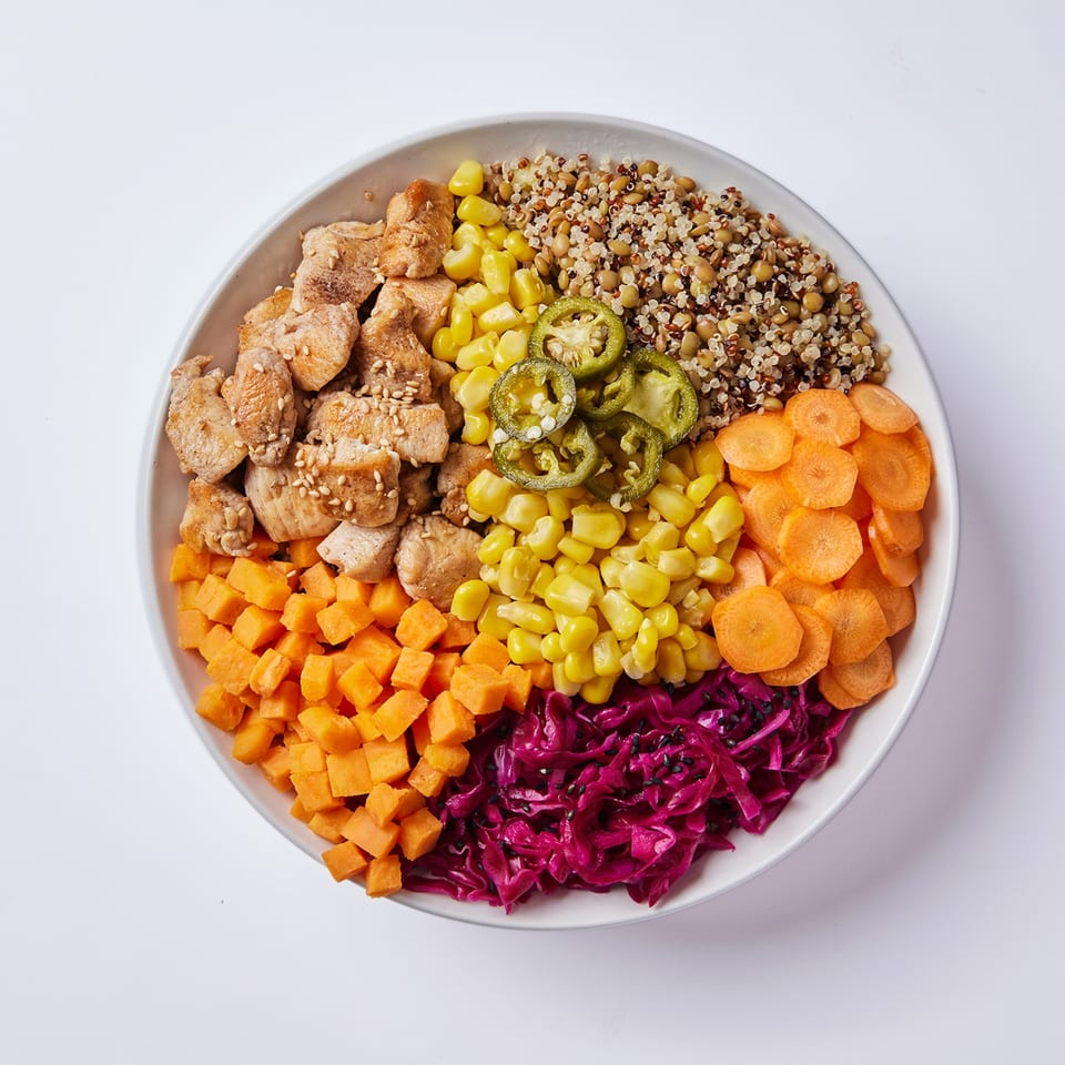 Inti Poke bowl with chicken, quinoa, corn, jalapenos, carrots, sweet potatoes, and red cabbage.